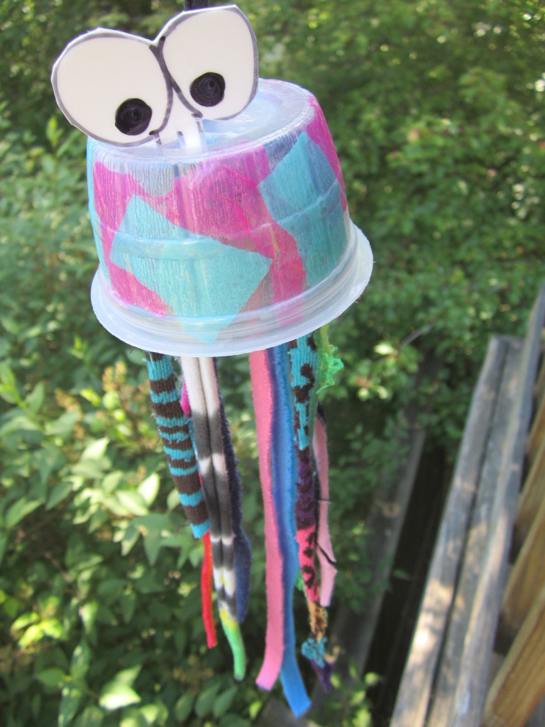 Jellyfish craft from recycled applesauce snack container and recycled socks