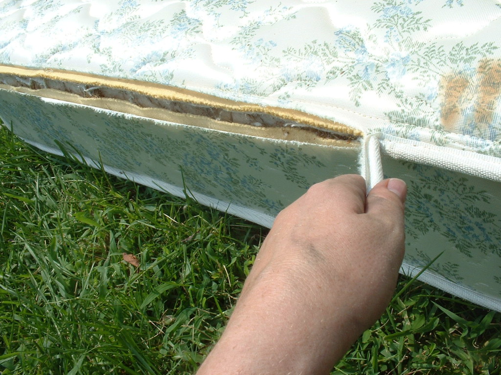 Removing the cord from the edge of the mattress