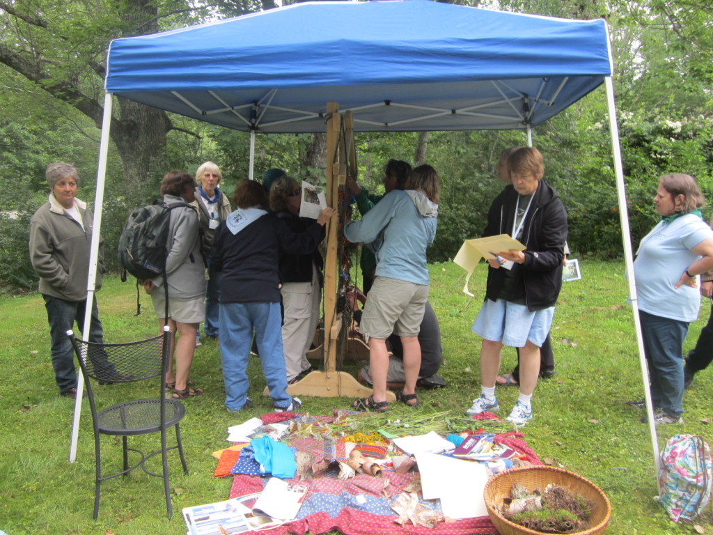 Summiteers adding items to the Weaving a Life loom
