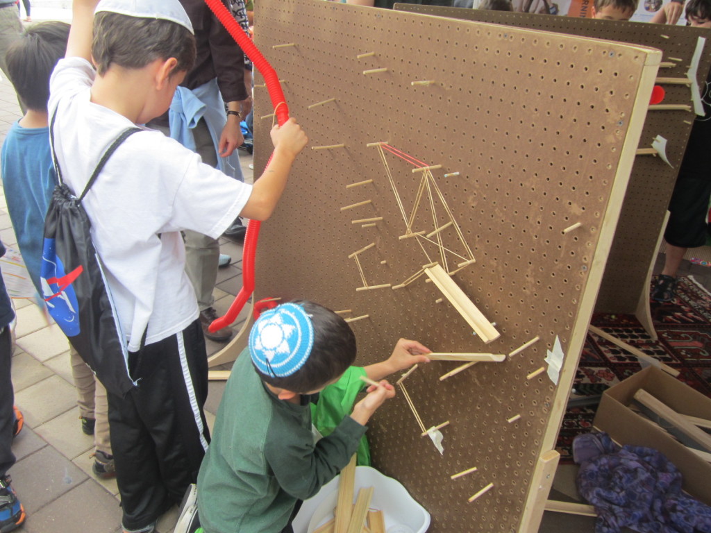 Marble run made from a pegboard, pegs, bamboo, tubes and rubber bands