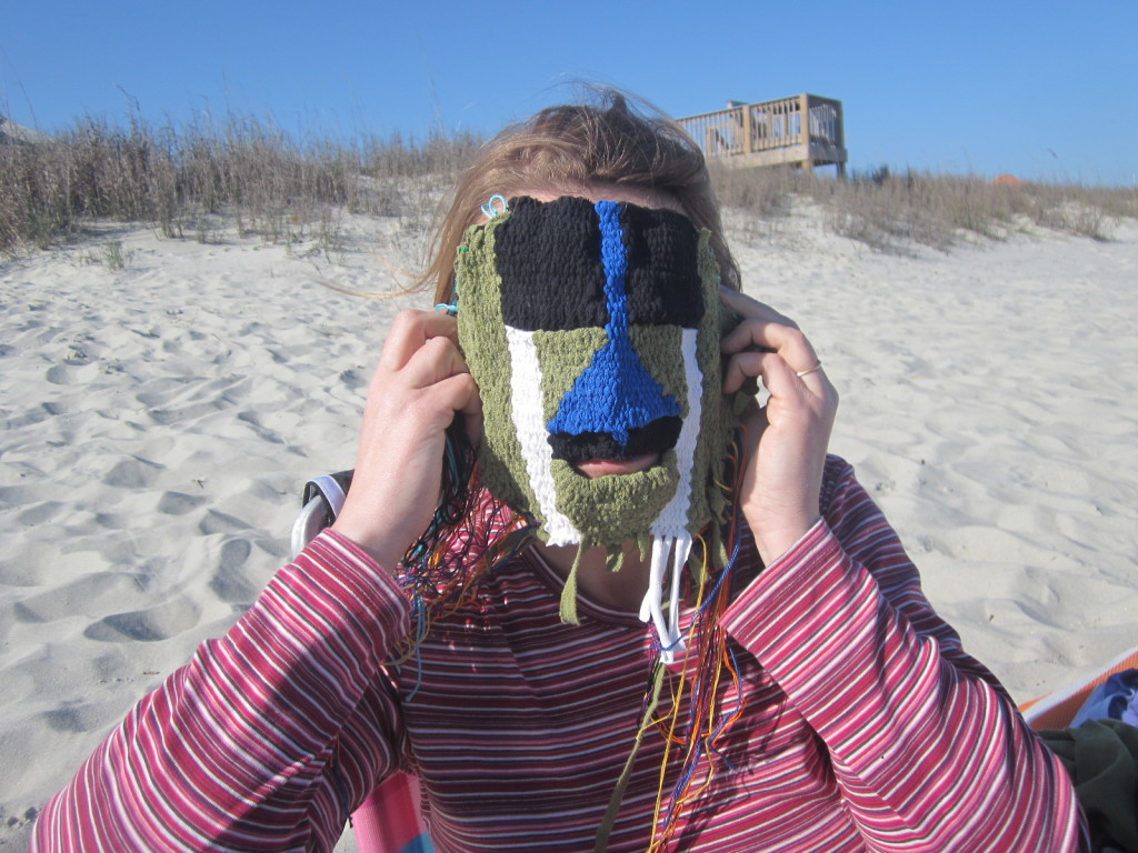 Carla tries on the mask at the beach