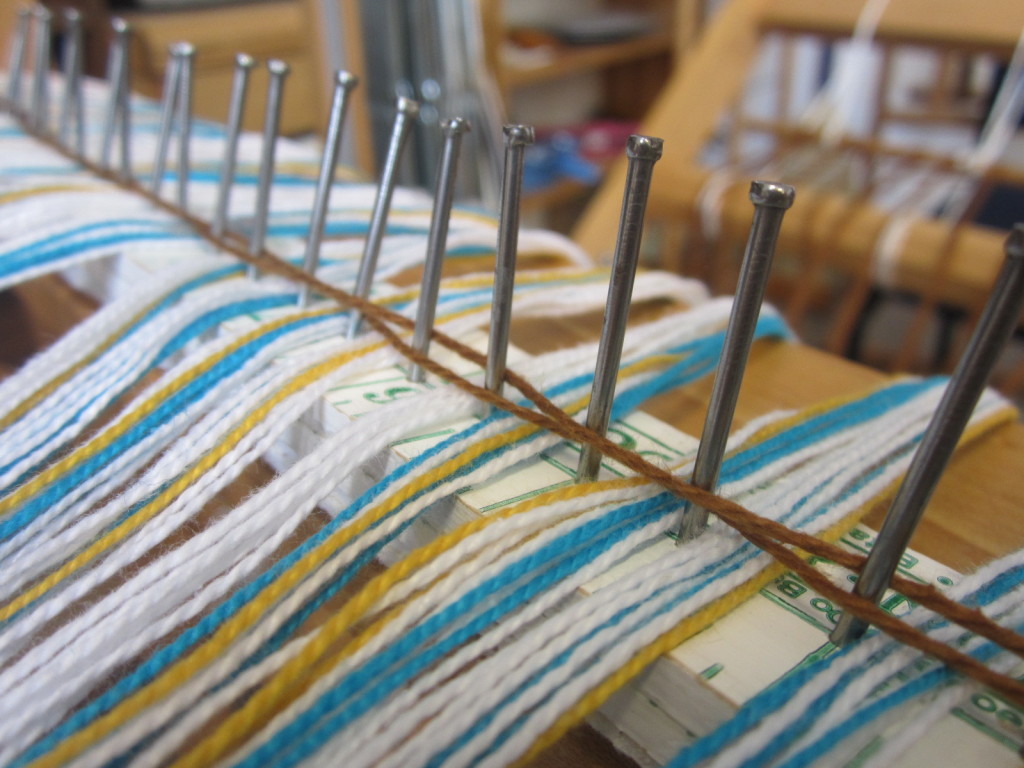 Keeping the warp on the rattle - tying it down with some yarn or rubber bands