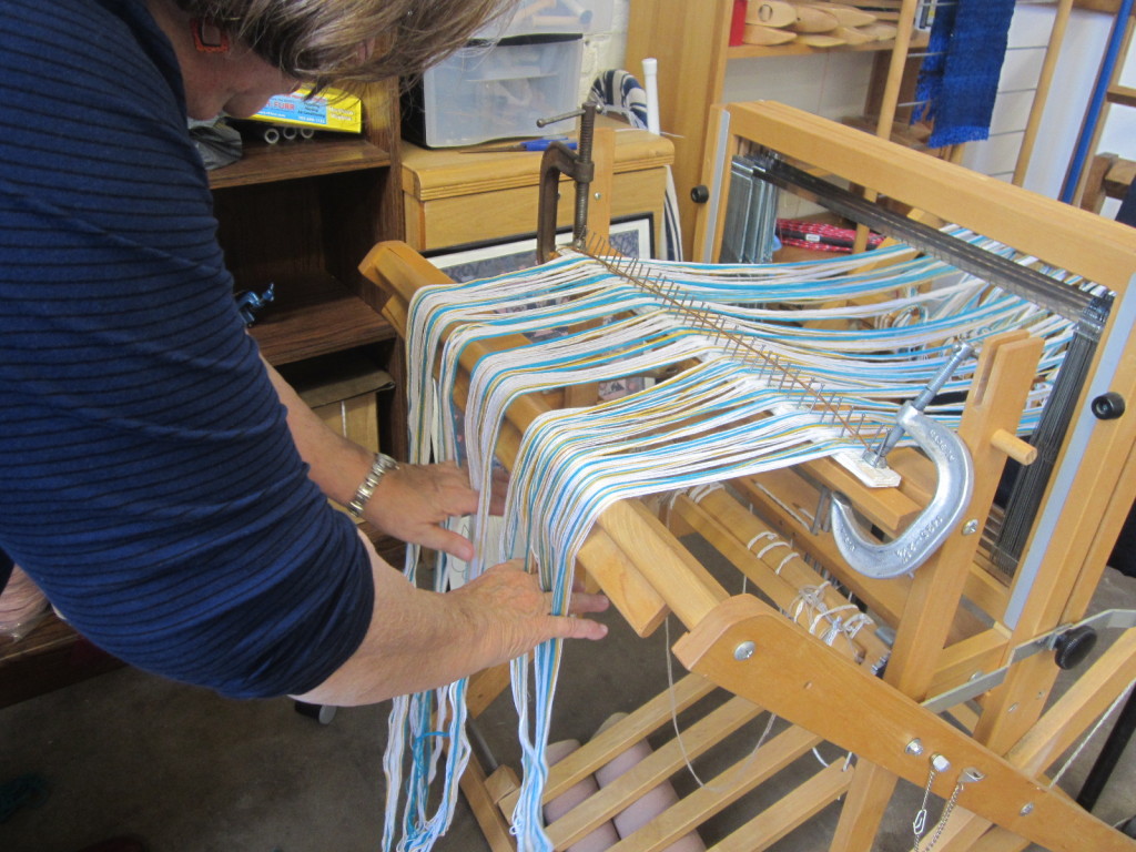 Straightening out the warp - NOT combing, but putting your weight on the warp