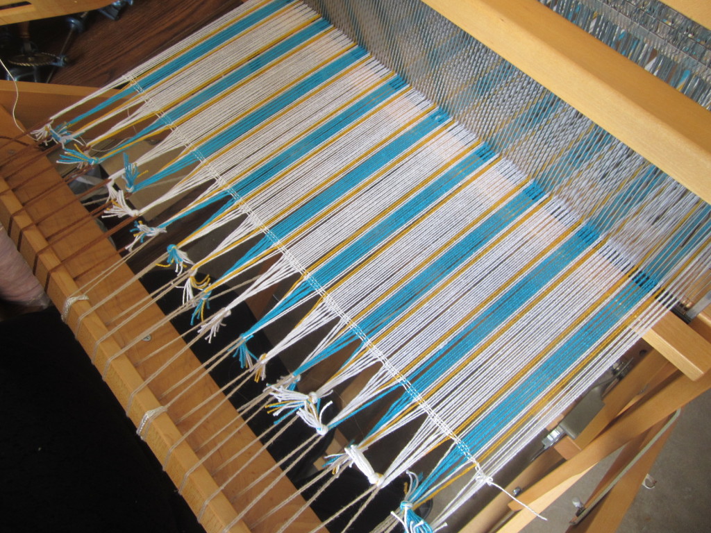 My warp with 3 weft threads to anchor it