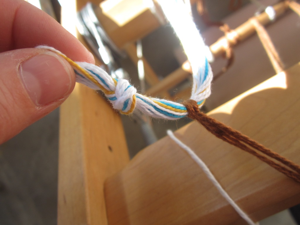 Cutting off the knots at the end of the warp