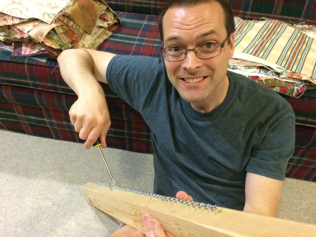 Bob adding screws to my Story Loom to make warping go faster