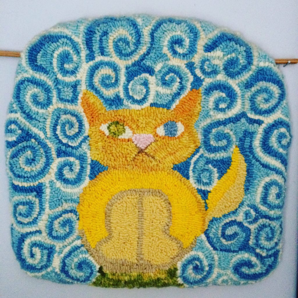 Kitty rug hooked from my daughter's drawing, inspired by the cat in the movie The Secret of Kells. The cat's name is Pangur Ban.