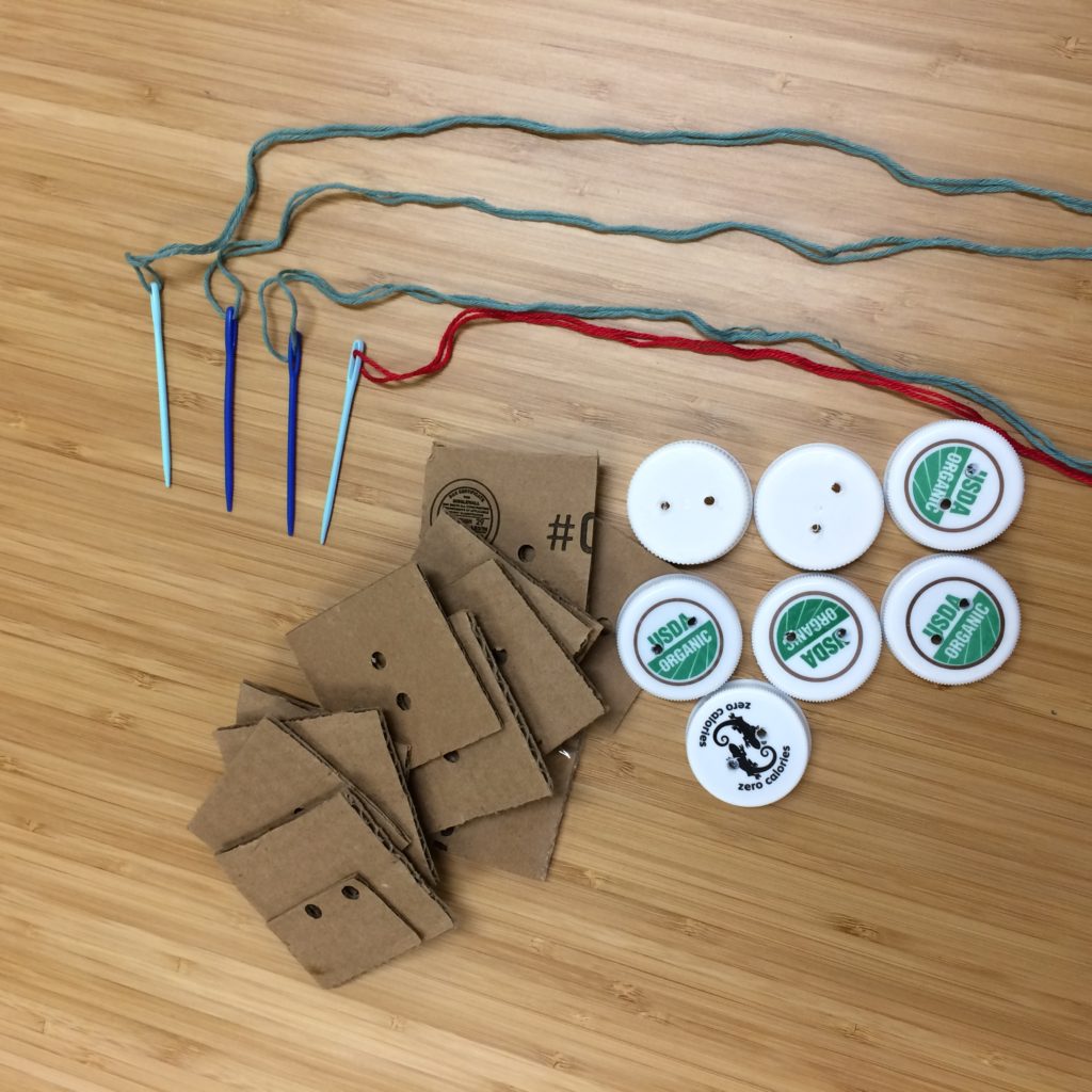 Sewing plastic cap "buttons" on cardboard - creative reuse station