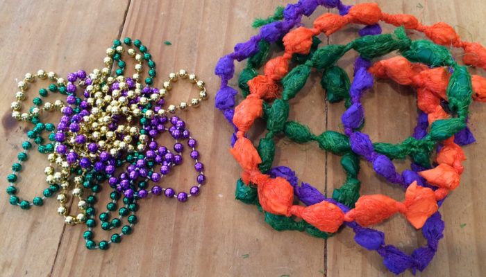 Typical Mardi Gras beads beside DIY Mardi Gras beads from plastic produce bags and table cloths - designed by Trashmagination