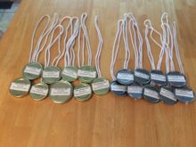 Gold and silver medals made from recycled lids and rope shopping bag handles