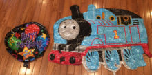 Mylar Balloons - round one says Happy Birthday to you and the other looks like Thomas the Train