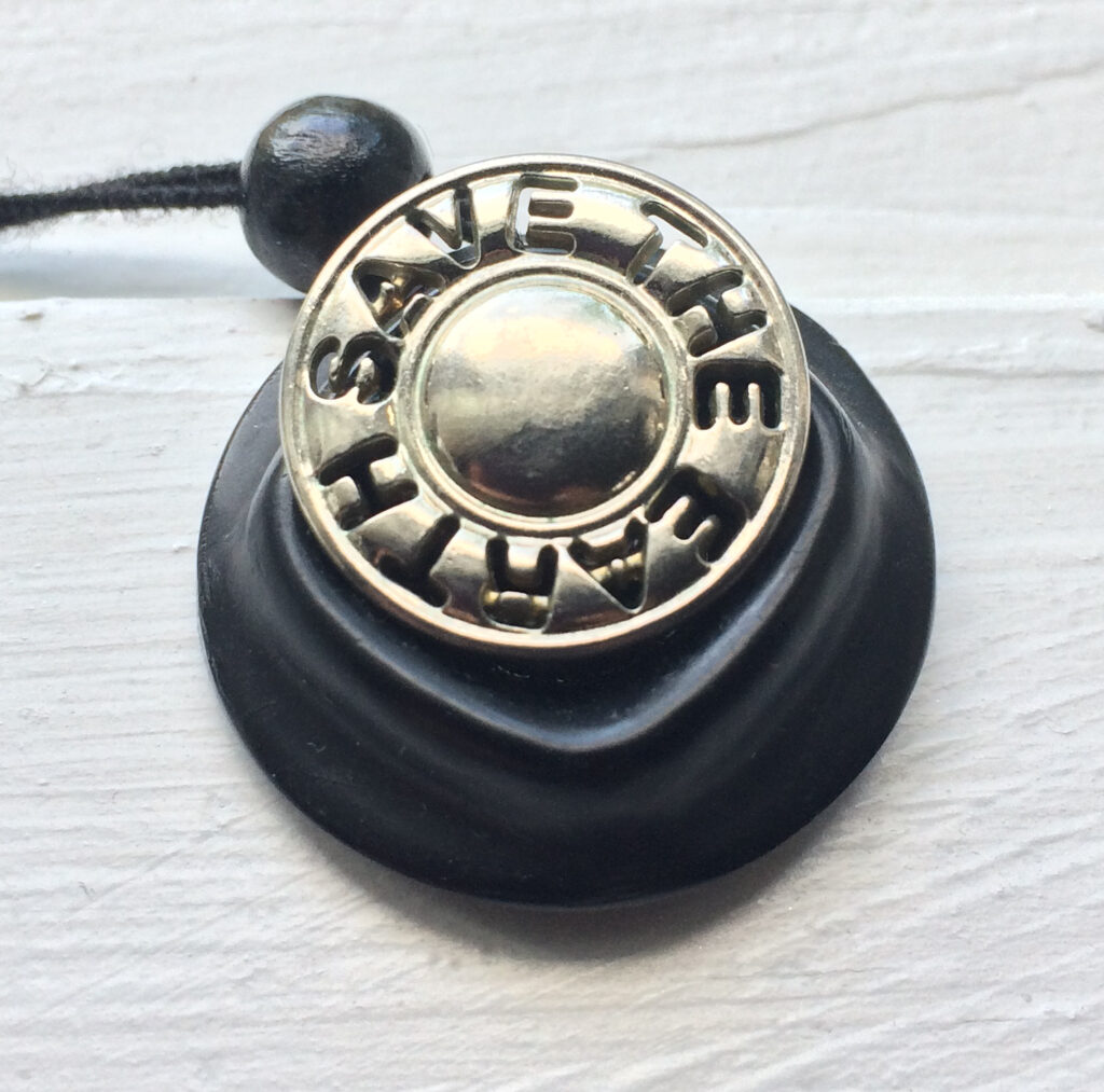 Necklace made from two buttons - a black one and a silver one that says "Save the Earth"
