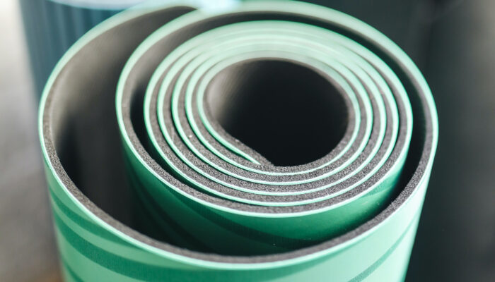 Rolled up green yoga mat