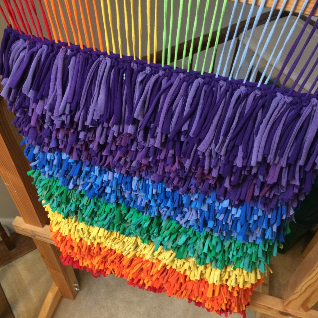 View of the rainbow rug from above on the tapestry loom