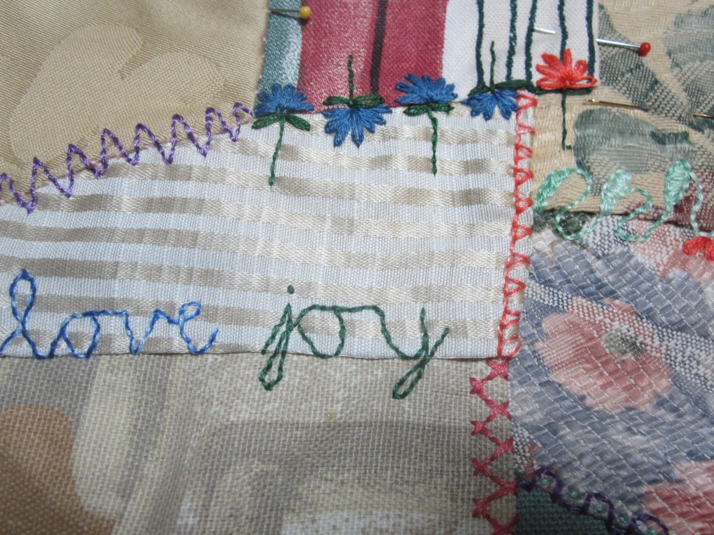 A small section from one of my crazy quilts showing cursive handwriting as a type of stitch