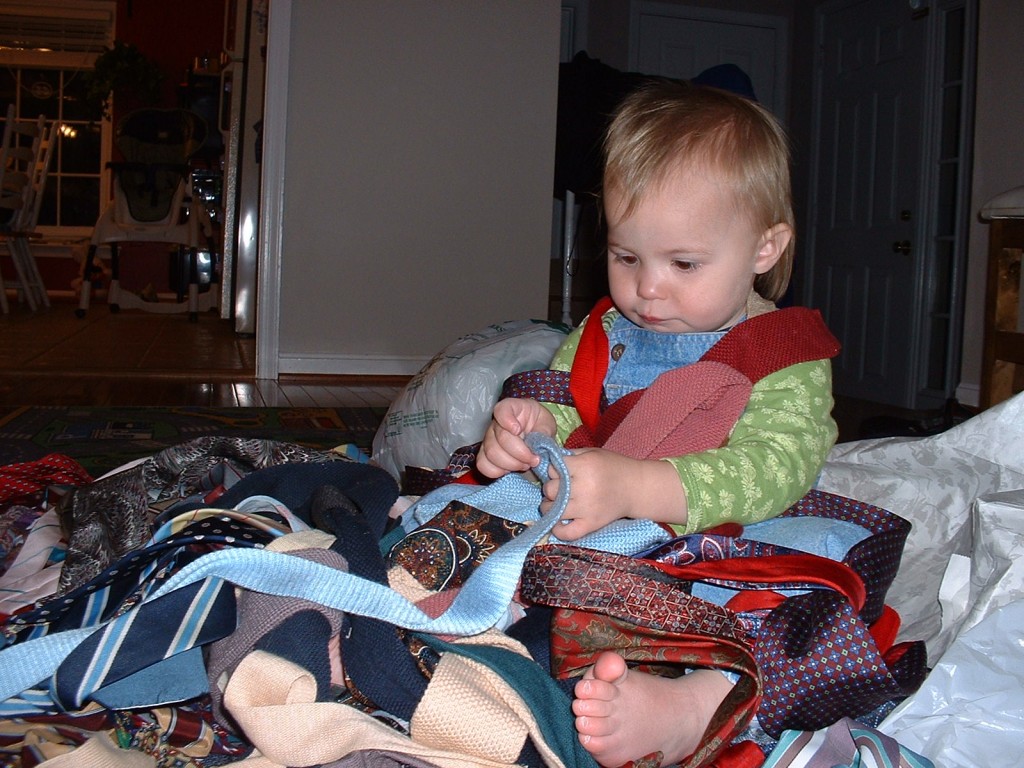 My daughter Nora playing with a pile of men's ties that I got on Freecycle