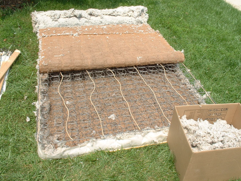 Mattress with the coir layer pulled back - metal springs visible