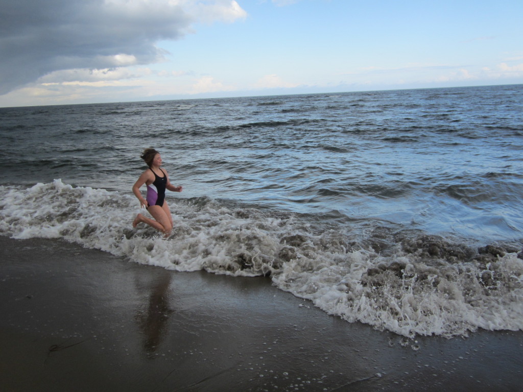 Nora runs in the waves at Kouchibouguac National Park