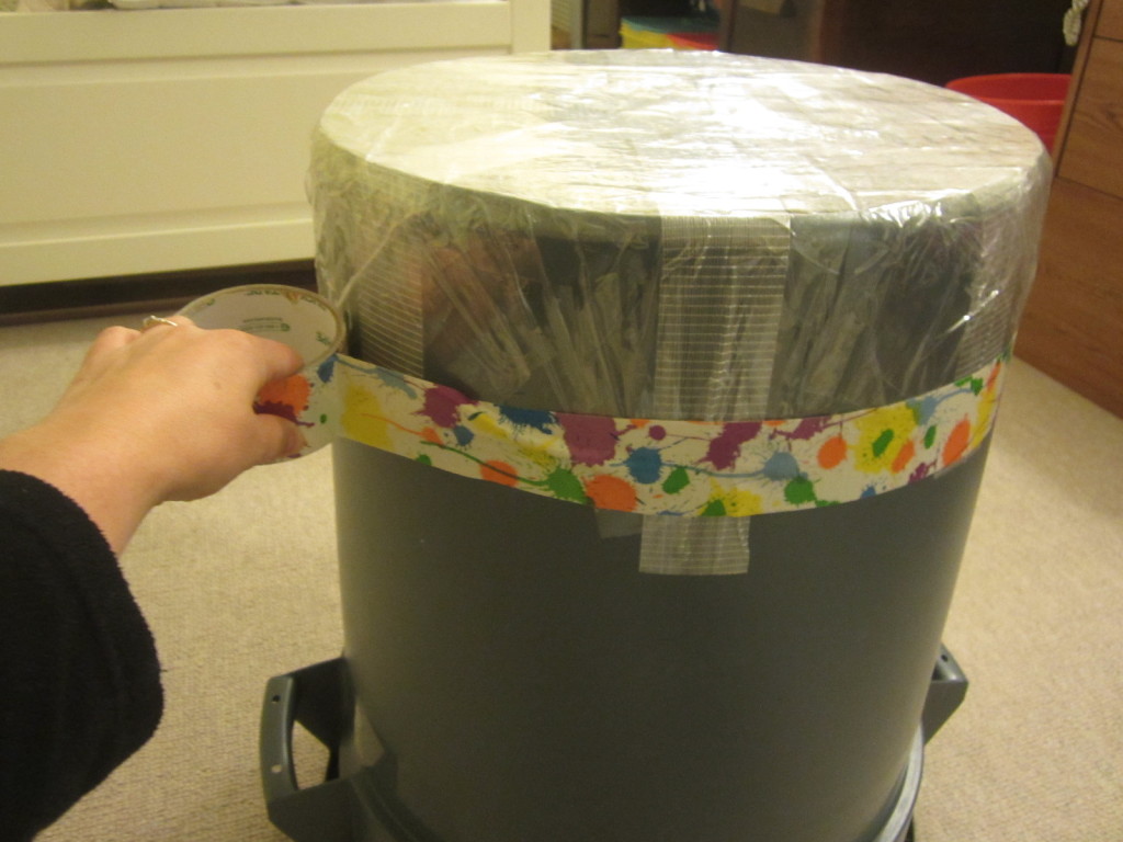 Adding the duct tape to the garbage can taiko drum