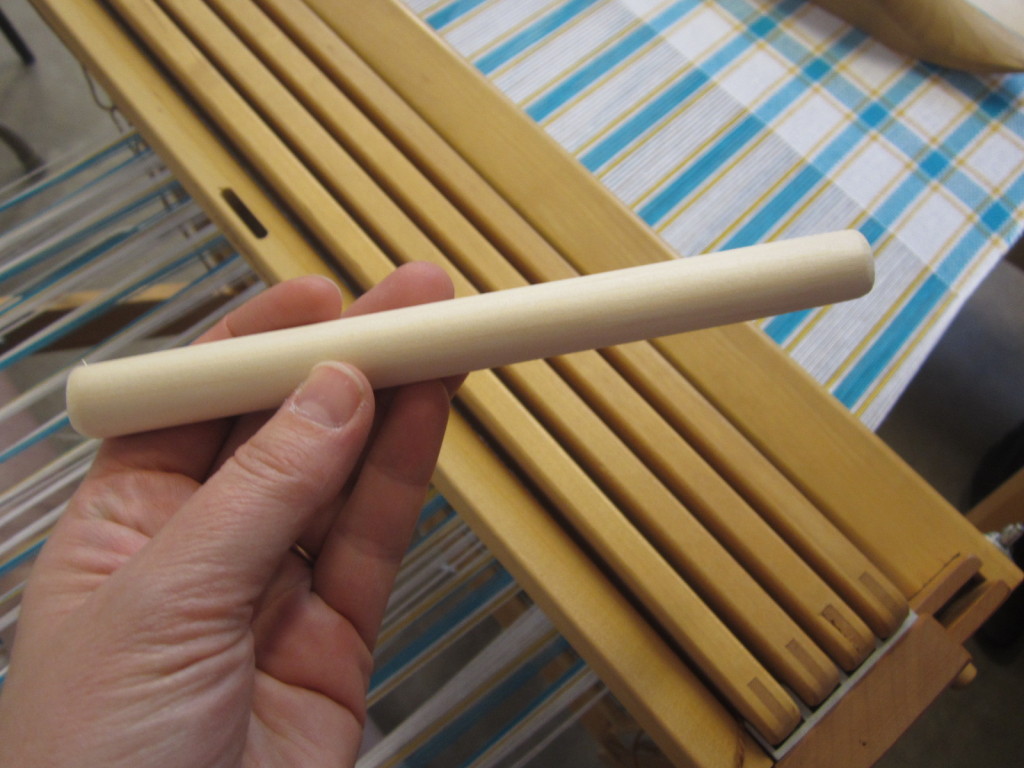 A rounded stick - to add tension during weaving
