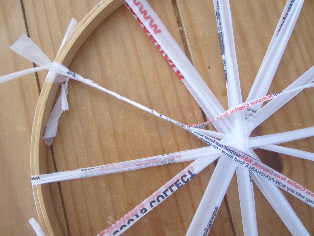 Wrap the two spokes together with another loop from the outside to the center