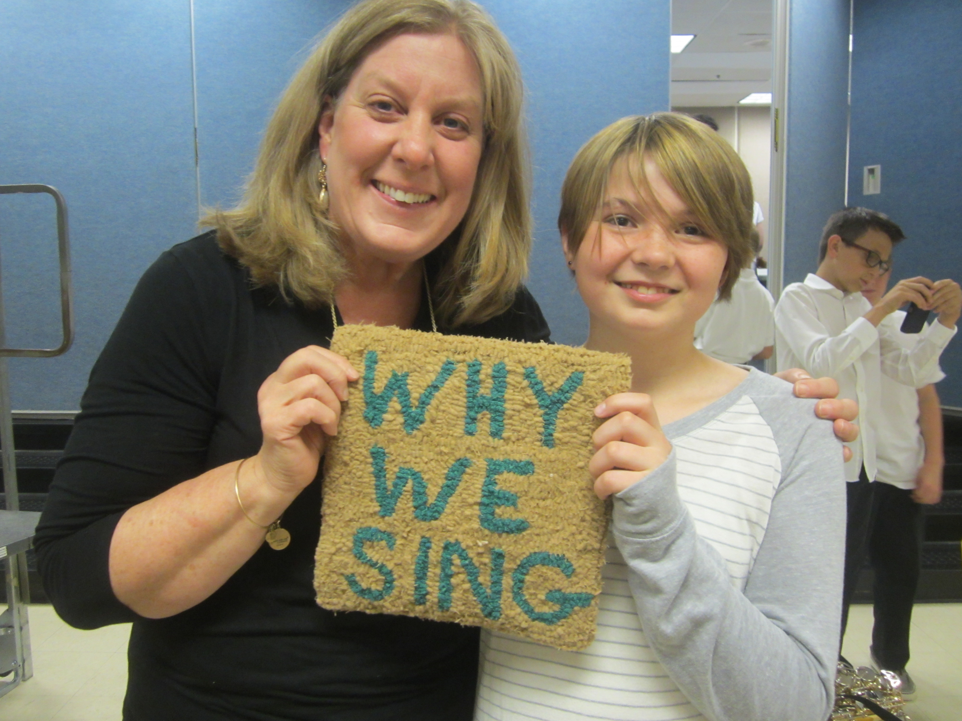 Giving Ms. Anderson the Why We Sing Rug at Year-End Concert