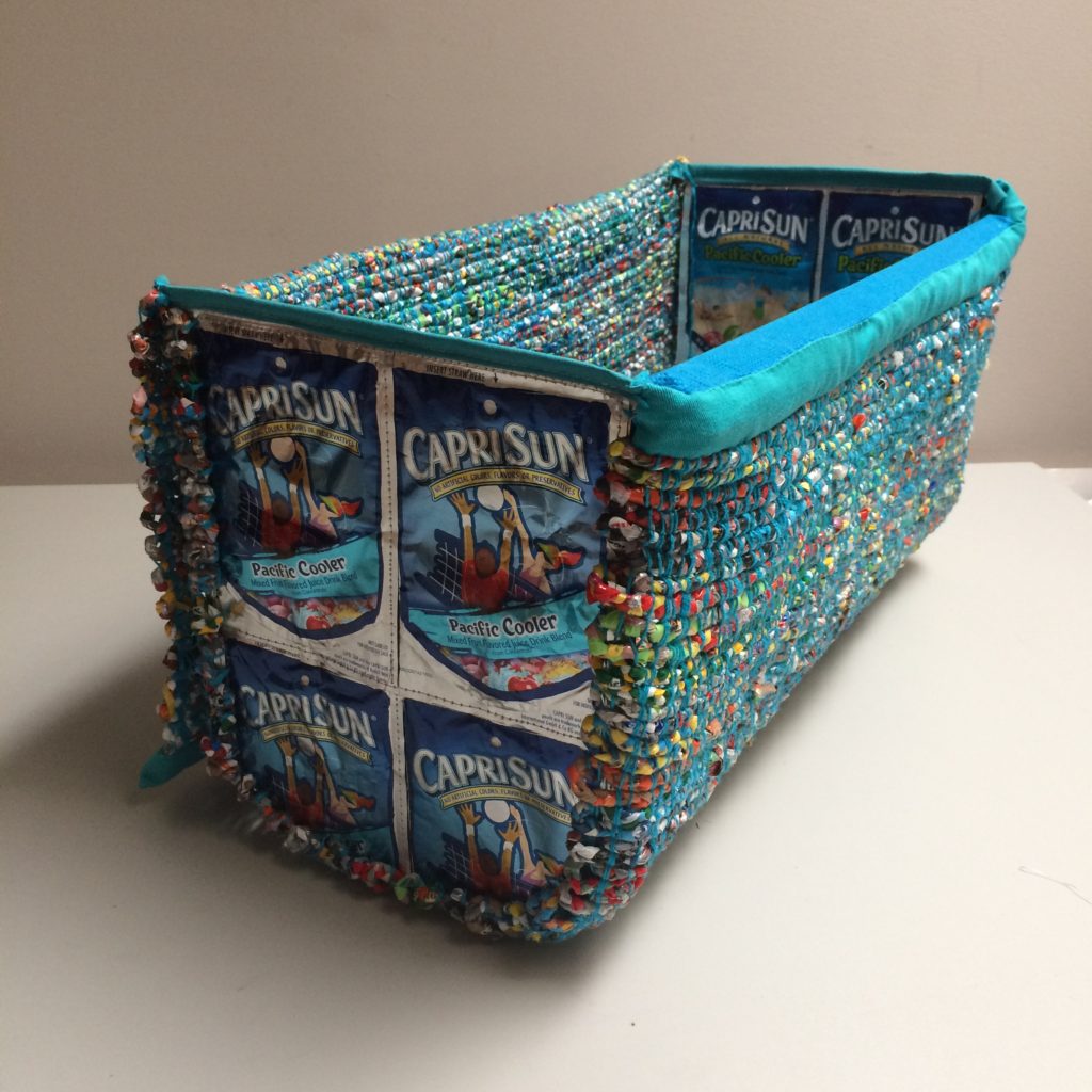 Storage basket made from woven plastic bags, clementine wooden box and juice pouches by Trashmagination