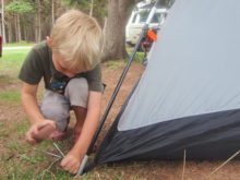 My son helping to put up our tent, August 2012
