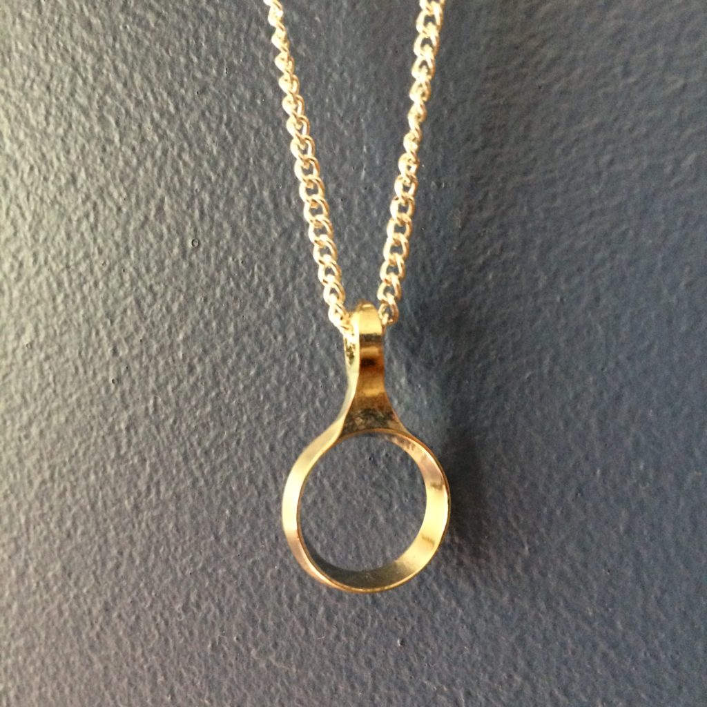 Pendant on a necklace made from an upcycled clarinet key by Music as Art by Sarah