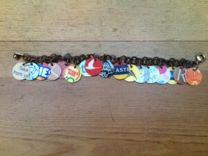 Bracelet made from colorful circles of plastic cut from laundry soap jugs and gift cards
