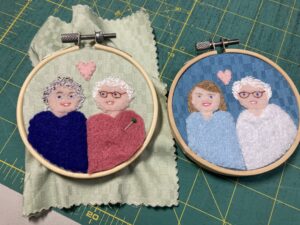 Two small portraits sewn with fabric and felt in 3-inch embroidery hoops