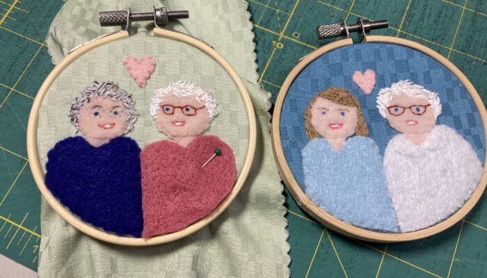 Two small portraits sewn with fabric and felt in 3-inch embroidery hoops